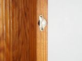 a close up of a door handle on a wooden door