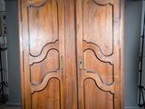 une grande armoire en bois surmontée de deux portes