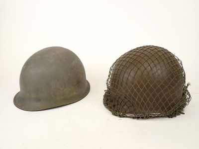 two helmets are sitting next to each other on a white surface