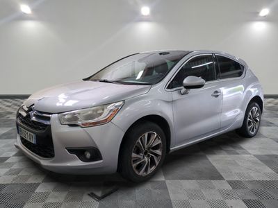 a white car is parked in a room with a checkered floor