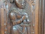 an image of a wooden door with a carving of a man holding a sword