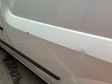 a white van parked on the side of the road