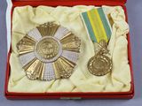 a gold medal and a silver medal in a red box