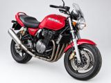the red motorcycle is parked against a white background