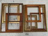 three different sized wooden picture frames on a white wall