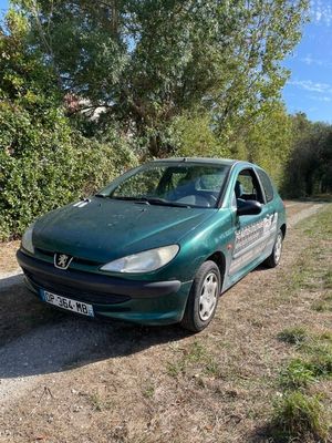 a small green car parked on the side of the road