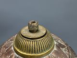 a close up of a vase with a lid on a table
