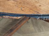 a close up of a table with a piece of wood on top of it