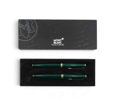 a green fountain pen in a black box on a white surface