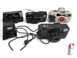 four cameras that are sitting next to each other on a table