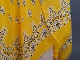a close up of a yellow scarf on a mannequin head