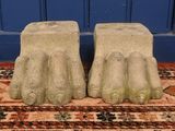a pair of stone foot stools on a rug