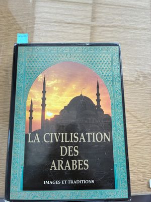 the book is sitting on a table in front of a window