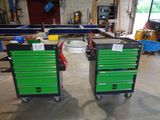 two green drawers on wheels in a garage