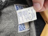 a person holding a wooden toothbrush in their pocket
