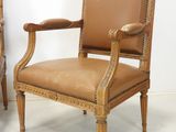 pair of antique chairs with leather upholstered back and arms