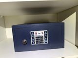 a blue safe box sitting on a shelf in a room
