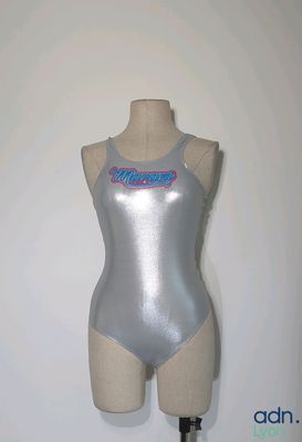 a mannequin with a silver bodysuit on a mannequin stand
