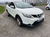 the white nissan qx - v is parked in a parking lot