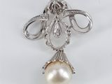 a white pearl and diamond pendant on a silver chain