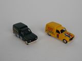 two toy cars that are next to each other on a white surface