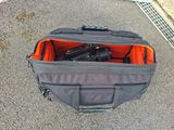 a bag with a camera inside of it sitting on the ground
