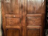 a large wooden armoire with two doors on each side
