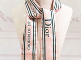 a close up of a mannequin with a pink and green striped scarf on it
