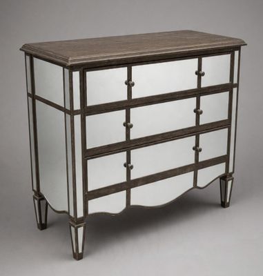 a dresser with mirrored drawers and a wooden top