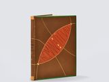 a brown and green book with a leaf design on the cover