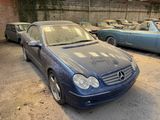 a blue car parked in a parking lot with other cars