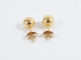 a pair of gold earrings on a white background