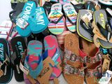 many pairs of flip flops that are on a table