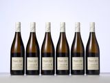 six bottles of wine are lined up in a row on a table