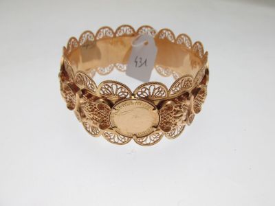 an image of a close up of a gold bracelet with a tag on it