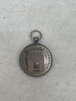 a small silver coin with a picture of a castle on it