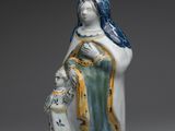 un gros plan sur une figurine représentant une femme tenant un enfant dans ses bras