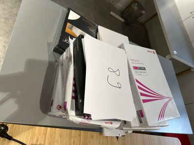 a desk with a bunch of papers and a phone on it