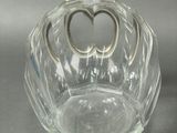 a glass vase with a heart shaped decoration on it