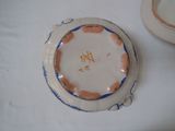 a white plate with a blue and orange design on it
