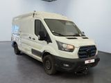 the white van is parked in the large room of the building