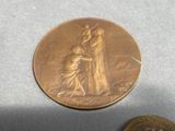a coin with a picture of a woman and a dog on it