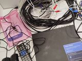 many wires and remotes that are on the table