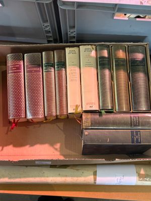a lot of books that are on a shelf