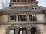 a wooden model of a building with a clock on the top of it