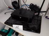 an image of a desk with a laptop and a router