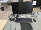 a desk with a keyboard, mouse, and monitor on it