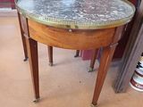 a small table with a marble top in a room