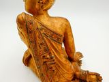 an image of a statue of a person sitting on a white surface