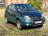 a picture of a small car parked in a field